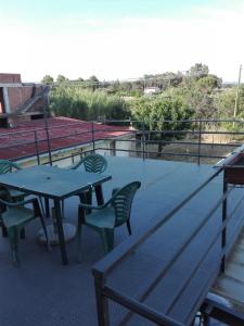 a patio with a table and chairs on a roof at Casa Graziella in Cecina