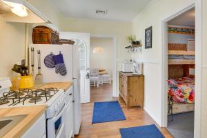 a kitchen with a white stove top oven in a room at Cozy Jersey Shore Cottage with Beach Chairs! in Wildwood