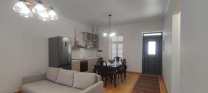 a living room with a couch and a table and a kitchen at Patriko in Spartochori in Spartokhórion