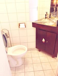 a bathroom with a toilet and a sink at OLYMPE in Saint-Denis