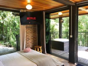 a screened in porch with a bed on a deck at Casa Container 80 in Campos do Jordão