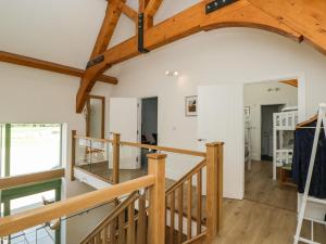 a view of the living room and dining room with wooden beams at The Old Barn in Witney