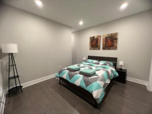 a bedroom with a bed and a lamp in it at Modern 2BR 2BA Apartment with rooftop in Brewerytown in Philadelphia