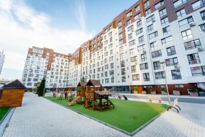 a playground in front of a large building at 2-Bedroom Family Grandeur Apartment in Chişinău