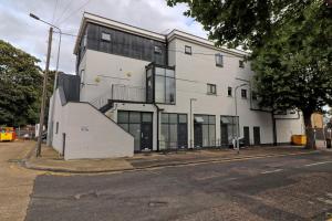 a white building on the corner of a street at Plush Nest - Charming One-Bedroom Flat - Southend Stays in Southend-on-Sea