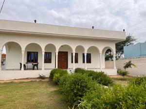 a white building with a table in front of it at Silver Sands homestay in Mandāwa