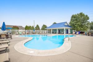a swimming pool at a resort with tables and chairs at Millville by the Sea --- 39008 Seascape Ct in Millville