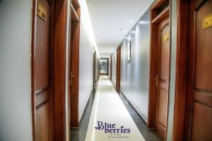 a hallway of a building with a sign that says blue benefits at Blueberries Hotel in Entebbe