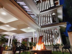 a fireplace in the lobby of a house at The Cana's Coorg in Ammatti
