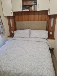 a bedroom with a large bed with a wooden headboard at Beautiful 3 bedroom holiday home Amazing views in Gisburn