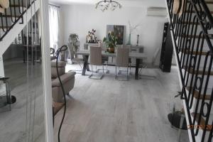 a living room with a table and a staircase at Studio dans villa proche de la plage in Sète +13 photos