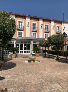 a large building with a fountain in front of it at Hotel Don Gonzalo in Montilla
