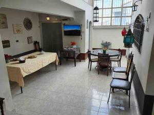 a living room with a table and a dining room at Casa espetacular com piscina para grupos - Glamour e lazer in São Paulo