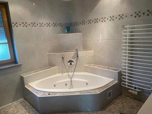 a bath tub in a bathroom with a shower at Ferienwohnung Regau 