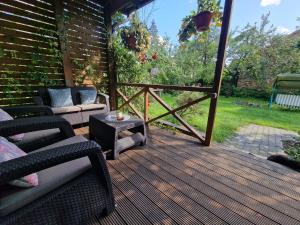 a wooden deck with a couch and a table at Boutigue city house with terrace and garden free parking in Rīga