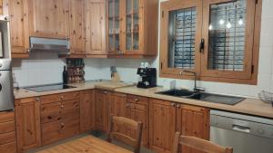a kitchen with wooden cabinets and a sink at Es Cantonet in Calvià