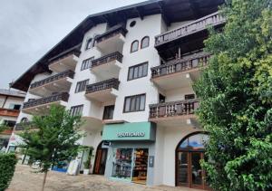 a large white building with balconies on it at Studio Thaler in Treze Tílias