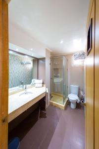 a bathroom with a sink and a toilet at Malak Hotel in Rabat