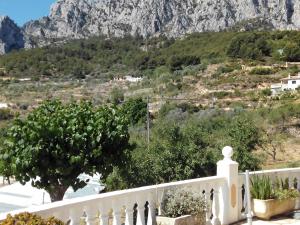a white balcony with a view of a mountain at Rincón De Pepe in El Castell de Guadalest +10 photos