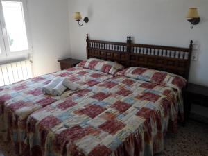 a bedroom with a bed with a pillow on it at Rincón De Pepe in El Castell de Guadalest