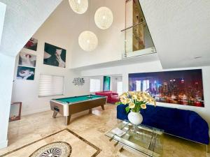 a living room with a pool table and a blue couch at *BEST House in MIAMI - Pool, Fashion, Central in Tamiami