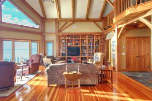 a living room with a couch and a tv at Waterfront Lake Champlain Home with Hot Tub and Sauna! in Melville Landing