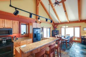 a kitchen with a large island with a dining table at Lake View Champlain Home with Hot Tub and Sauna! in Melville Landing