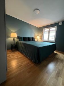 a bedroom with a large bed with a window at Horten center in Horten