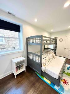 a bedroom with a bunk bed and a window at Beautifully Renovated House 10 mins from Downtown in Chicago