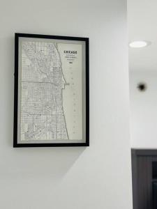 un mapa enmarcado colgando de una pared blanca en Beautifully Renovated House 10 mins from Downtown, en Chicago