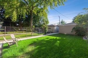 a yard with a bench in the grass at Beautifully Renovated House 10 mins from Downtown in Chicago