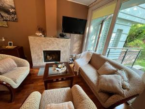 a living room with two couches and a fireplace at Villa 24B in Pobierowo