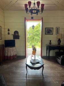 a living room with a table and a window at Casa Vieja Mountain Lodge in Ayacucho