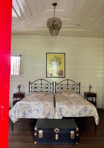 a bedroom with a bed with a suitcase on it at Casa Vieja Mountain Lodge 