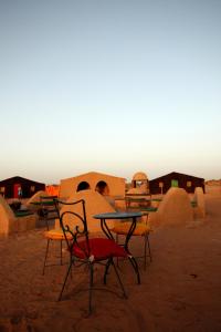 a group of tables and chairs in the desert at Bivouac M'hamid Le Pacha in Mhamid