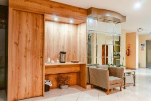 a lobby with a desk and a chair and a table at Cesar´s Hotel La Merced in Trujillo