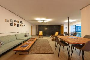 a living room with a couch and a table at Hostal Casa Mosaiko Primer Parque-Laureles in Medellín