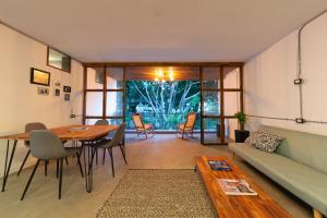 a living room with a table and a couch at Hostal Casa Mosaiko Primer Parque-Laureles in Medellín