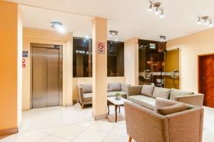 a lobby with couches and a table in a building at Cesar´s Hotel La Merced in Trujillo