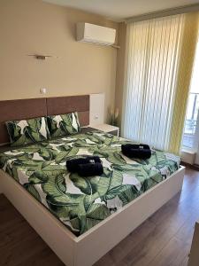 a bedroom with a bed with two bags on it at Ultra Lux Apartment Free Underground Parking in Pazardzhik