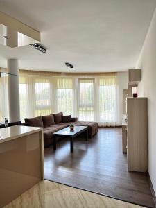 a living room with a couch and a table at Ultra Lux Apartment Free Underground Parking in Pazardzhik