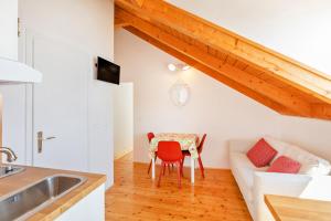 a kitchen and a living room with a table and a couch at Tik tak Dubrovnik 2 in Dubrovnik