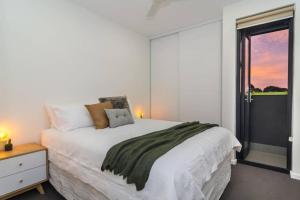 a bedroom with a large bed and a window at Canopy at 44 Ovingham in Bowden