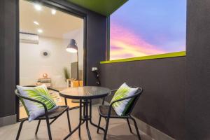 a room with a table and chairs and a window at Canopy at 44 Ovingham in Bowden