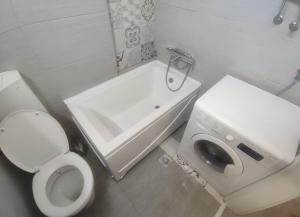a small bathroom with a toilet and a sink at Apartman Kvart in Sarajevo +15 photos