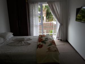 a bedroom with a bed and a window with a view at Abby's Guesthouse in Port Elizabeth +7 photos