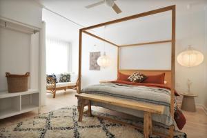 a bedroom with a canopy bed and a rug at Pine at Arlos Glenelg South in Glenelg