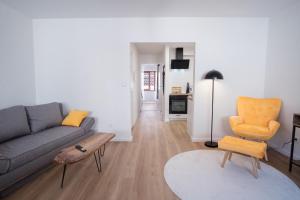 een woonkamer met een bank en een stoel bij NEU / Design / Altstadt / Küche / NETFLIX in Bad Säckingen
