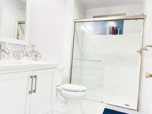 a white bathroom with a toilet and a shower at NEW 3BR/2BA house SJ Silicon W/D parking in San Jose