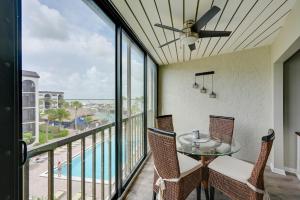 a balcony with a table and chairs and a view of the ocean at Waterfront Marco Island Condo with Pool and Hot Tub! in Marco Island